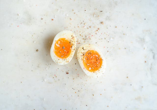 Spiced soft boiled egg on marble tabletop
